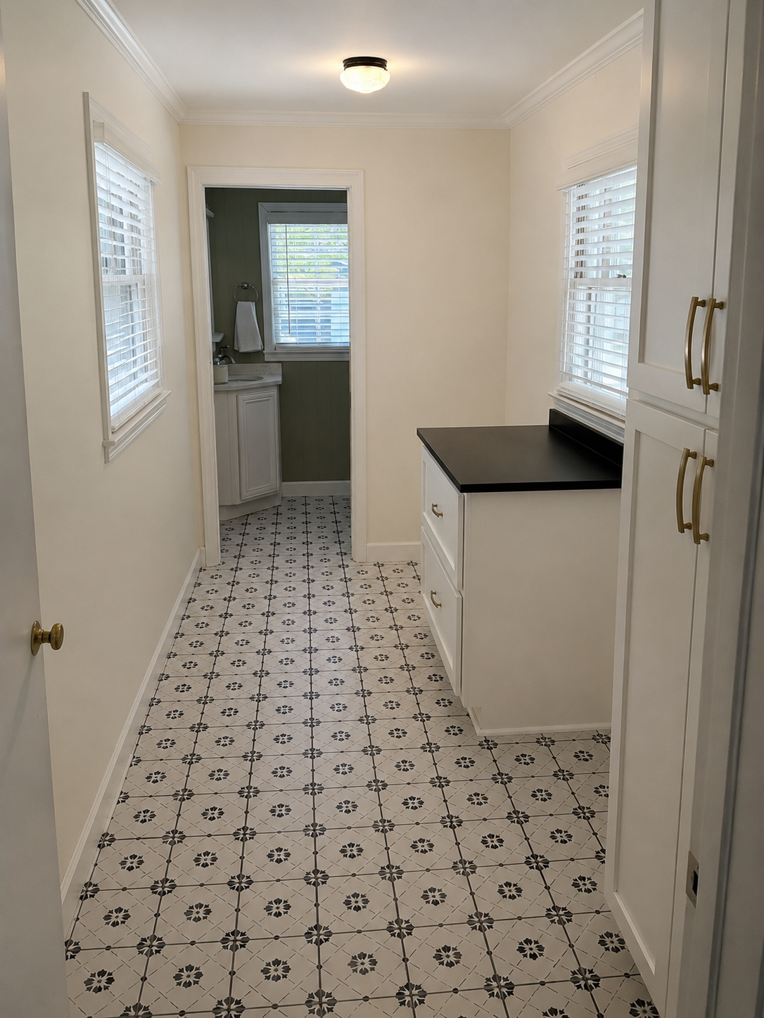 Same room after painting paneling white, fresh trim, and updated flooring