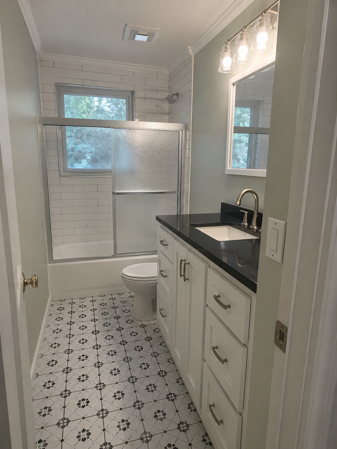 Same bathroom after wallpaper removal, fresh paint, and updated finishes