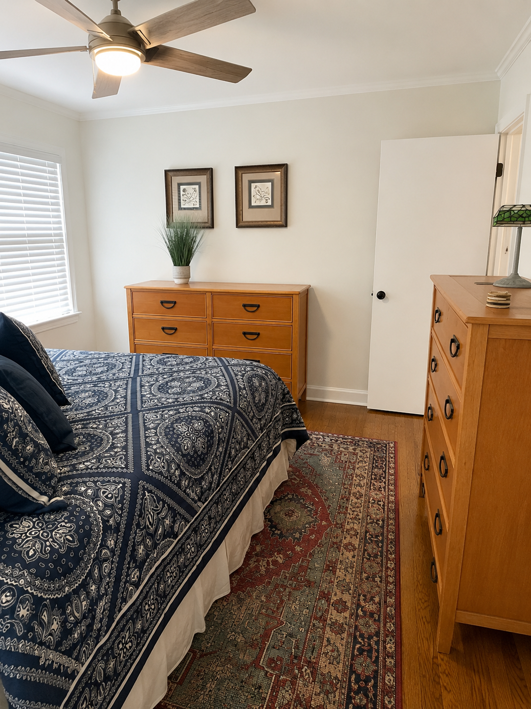 Same bedroom after wallpaper removal, painted clean and staged